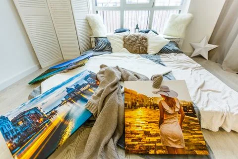 Frames collage with floral posters on bricks textured wall, over modern couch Stock-Fotos