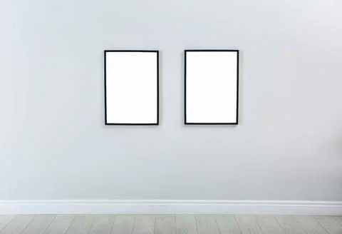Frames with empty canvases on wall in modern art gallery. Mockup for design Stock Photos