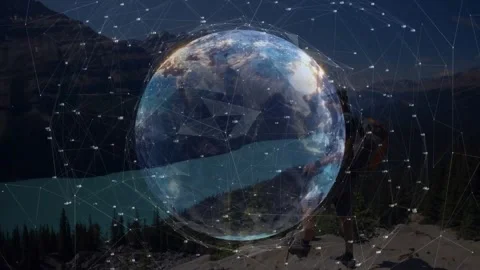 Frames initiating globe emerging over lake in tech demo while hiker scanning Stock Footage 317741465