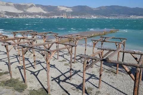 Frames of logs for awnings on the beach. The beach of Novorossiysk Stock Photos