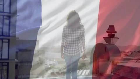 Frames progressing, woman walking to glass, pausing, seeking city view, flag Stock Footage 333485584