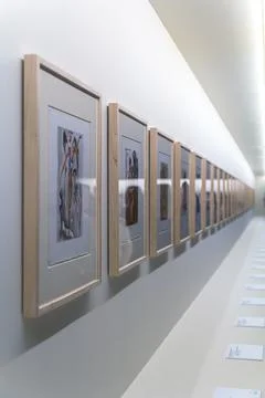 Frames with unreadable pictures on brick white wall Foto stock