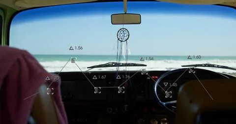 Framing camper van dash showing dreamcatcher hanging from rearview mirror facing Stock Photos