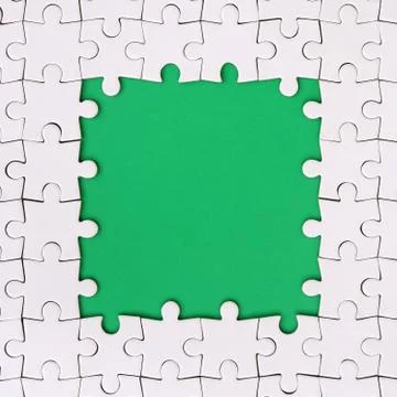Framing in the form of a rectangle, made of a white jigsaw puzzle around the  Foto stock