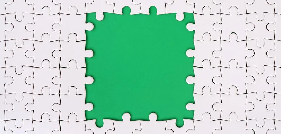 Framing in the form of a rectangle, made of a white jigsaw puzzle around the  Stock Photos