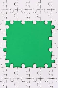 Framing in the form of a rectangle, made of a white jigsaw puzzle around the  Stock Photos