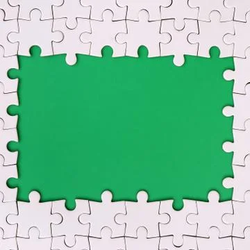Framing in the form of a rectangle, made of a white jigsaw puzzle around the  Stock Photos