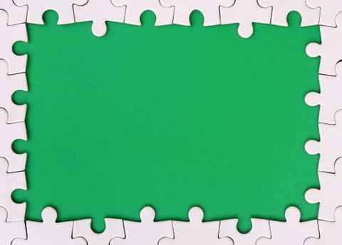Framing in the form of a rectangle, made of a white jigsaw puzzle around the  Stock Photos