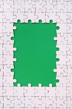 Framing in the form of a rectangle, made of a white jigsaw puzzle around the  스톡 사진