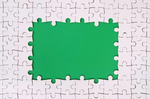Framing in the form of a rectangle, made of a white jigsaw puzzle around the  Stock Photos