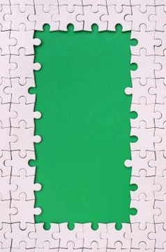Framing in the form of a rectangle, made of a white jigsaw puzzle around the  Stock Photos