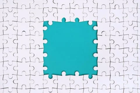 Framing in the form of a rectangle, made of a white jigsaw puzzle around the  Stock Photos