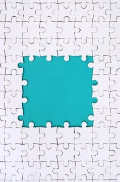 Framing in the form of a rectangle, made of a white jigsaw puzzle around the  写真素材