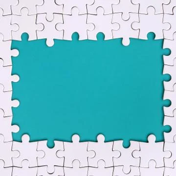 Framing in the form of a rectangle, made of a white jigsaw puzzle around the  Stock Photos