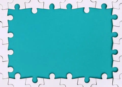 Framing in the form of a rectangle, made of a white jigsaw puzzle around the  Stock Photos