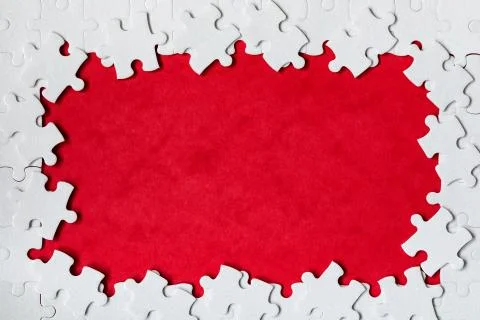Framing in the form of a rectangle, made of a white jigsaw puzzle. Frame text Foto stock