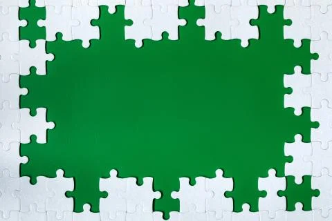 Framing in the form of a rectangle, made of a white jigsaw puzzle. Frame text Stock Photos