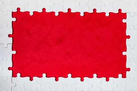 Framing in the form of a rectangle, made of a white jigsaw puzzle. Frame text Stock Photos