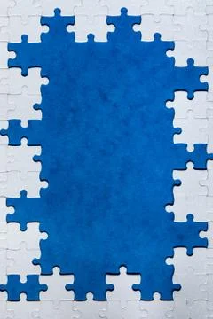 Framing in the form of a rectangle, made of a white jigsaw puzzle. Frame text Stock Photos