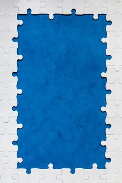 Framing in the form of a rectangle, made of a white jigsaw puzzle. Frame te.. Stock Photos