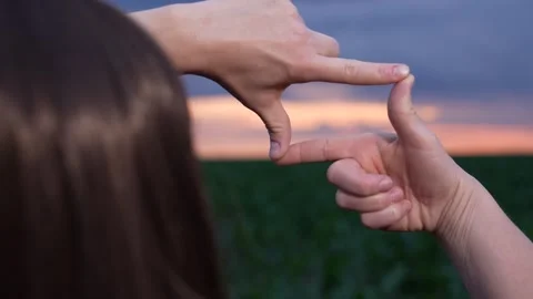 Framing the horizon, Unique perspective, Glowing dusk, Open field scene, Human Stock Footage 315530306