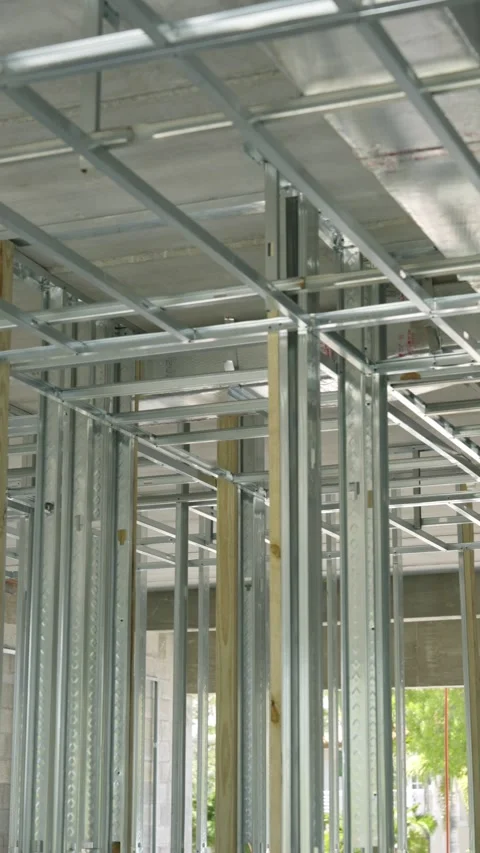 Framing of house under construction. Metal and wooden studs and beams. Structure Stock Footage 293851003
