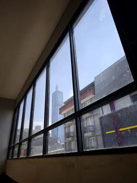 Framing of a skyscraper through the windows of a building Stock Photos