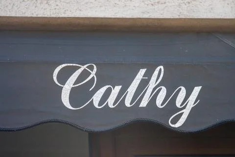 France, 16 August 2024: Storefront sign with the name "Cathy" on an awning. Foto stock