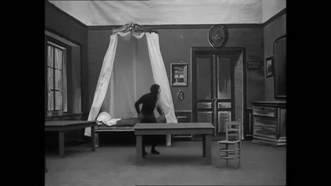 FRANCE - 1905 - In this silent comedy, a devil dances around a hotel room and Stock Footage 288081544