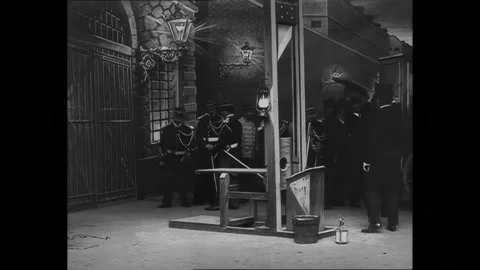FRANCE - 1906 - Executioners bring out a makeshift coffin and place it beside Stock Footage 296396592