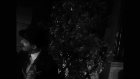 FRANCE - 1932 - in this comedy, two men toast each other at a café while the Stock Footage 330603291