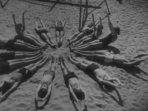 France - 1940s: Group exercise on beach Stock Footage 230544944