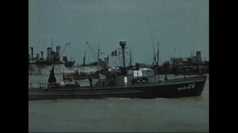 FRANCE - 1944: an armed trawler underway past the shore Stock Footage 340399024
