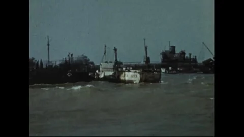 FRANCE - 1944: barges work around a floating pontoon pier Stock Footage 340398947