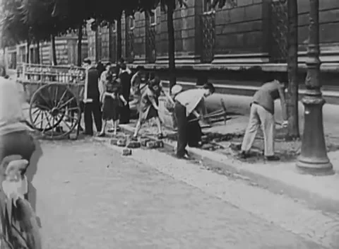 FRANCE - 1944: Barricade construction - Workers tear cobbles from roadway Video stock 344509874