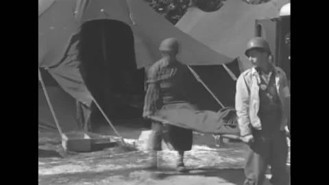 FRANCE - 1944 - Medics load wounded soldiers into ambulance trucks from an Video stock 287745274