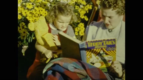 France 1958, Mother reads fairy tales to the child Stock Footage