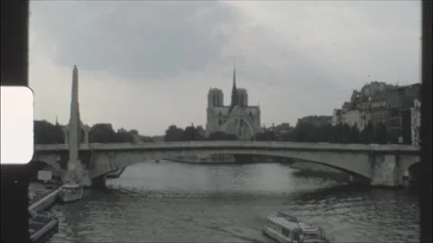 France 1970s, distant view of Notre Dame de Paris and bridge over the Seine Stock Footage 314328216