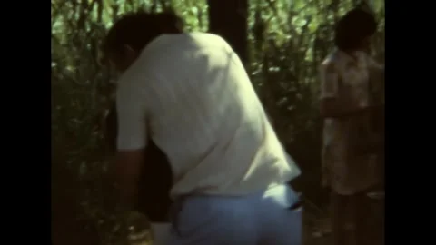 France 1972: Two drunk men embrace and stagger after outdoor lunch Vidéo 302292704