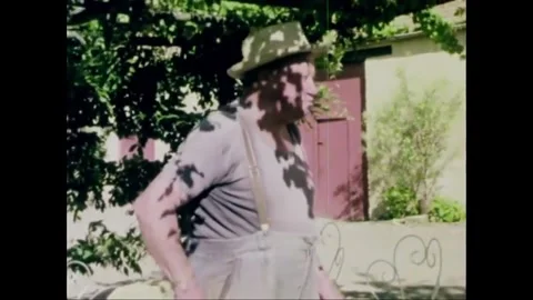 FRANCE - 1979 - A man pulls a bucket of wine bottles up from his well and Stock-Footage 264662092