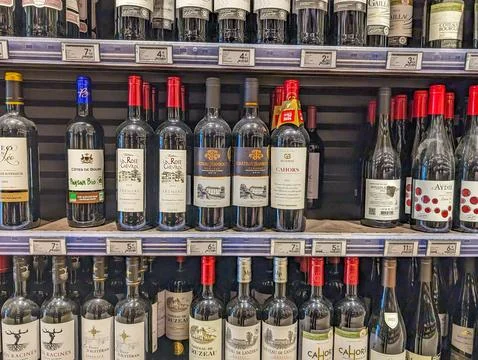 France, 23 May 2024: Various wine bottles displayed on supermarket shelf. Stock Photos