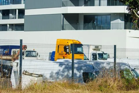 France, 8 September 2024: Parked trucks and vehicles behind a fence near mo.. Stock Photos
