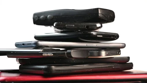 France-April 24, 2019, outdated models of mobile phones and smartphones on turnt Stock Footage 106924702