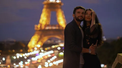 FRANCE, PARIS - OCT 2, 2017: Romantic Couple in love in Paris at Eiffel Tower in Stock Footage 98410773