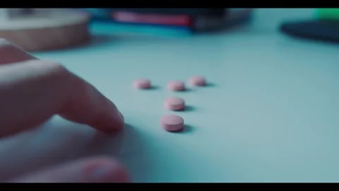 Frantic Finger Tapping Next to Medication on Table hesitating to take Medication Stock Footage 341620264