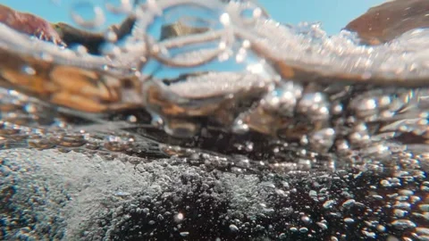 Frantic rush of rocky stream with an infinite stream of oxygen bubbles, half Stock Footage 331726262