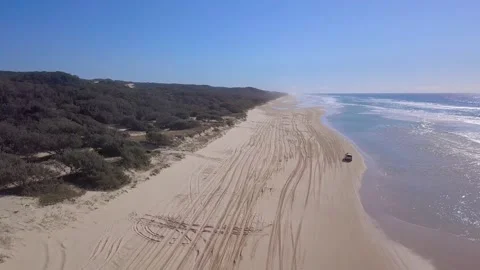 Fraser Island Queensland Australia crane up as car drives up beach Stock Footage 148456053