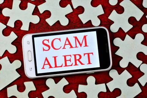 Fraud alert-a message on the smartphone screen. Stock Photos