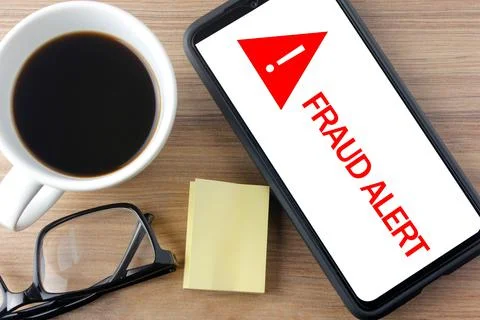 Fraud Alert message on smartphone screen caused by cyber attack Stock Photos