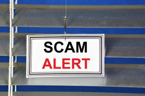 Fraud alert - text message in the banner sign on the hunting hook. Stock Photos